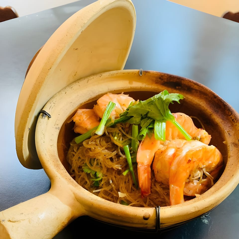 Thai Den's clay pot glass noodles with large shrimp, green onions, and cilantro.